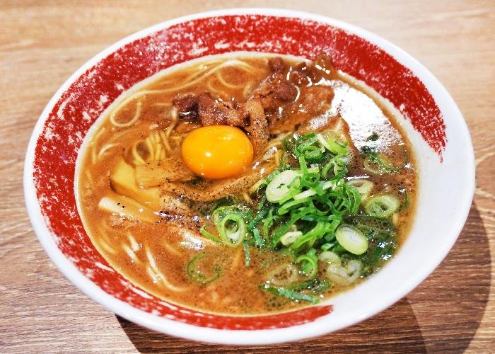 Tokushima Ramen with a thick concentrated broth, topped with an egg yolk and scallions